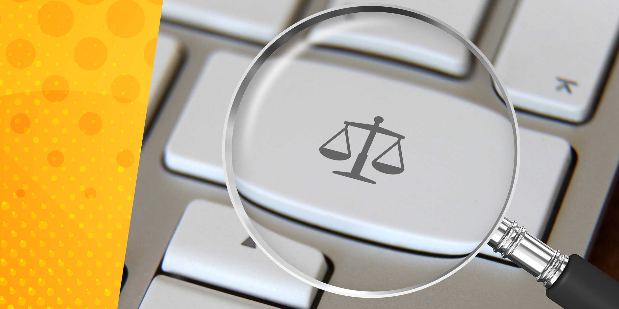 magnifying glass over keyboard with law scales icon